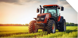 A red tractor sits in a green field under a bright sky at sunset, with sunlight casting warm tones over the scene.